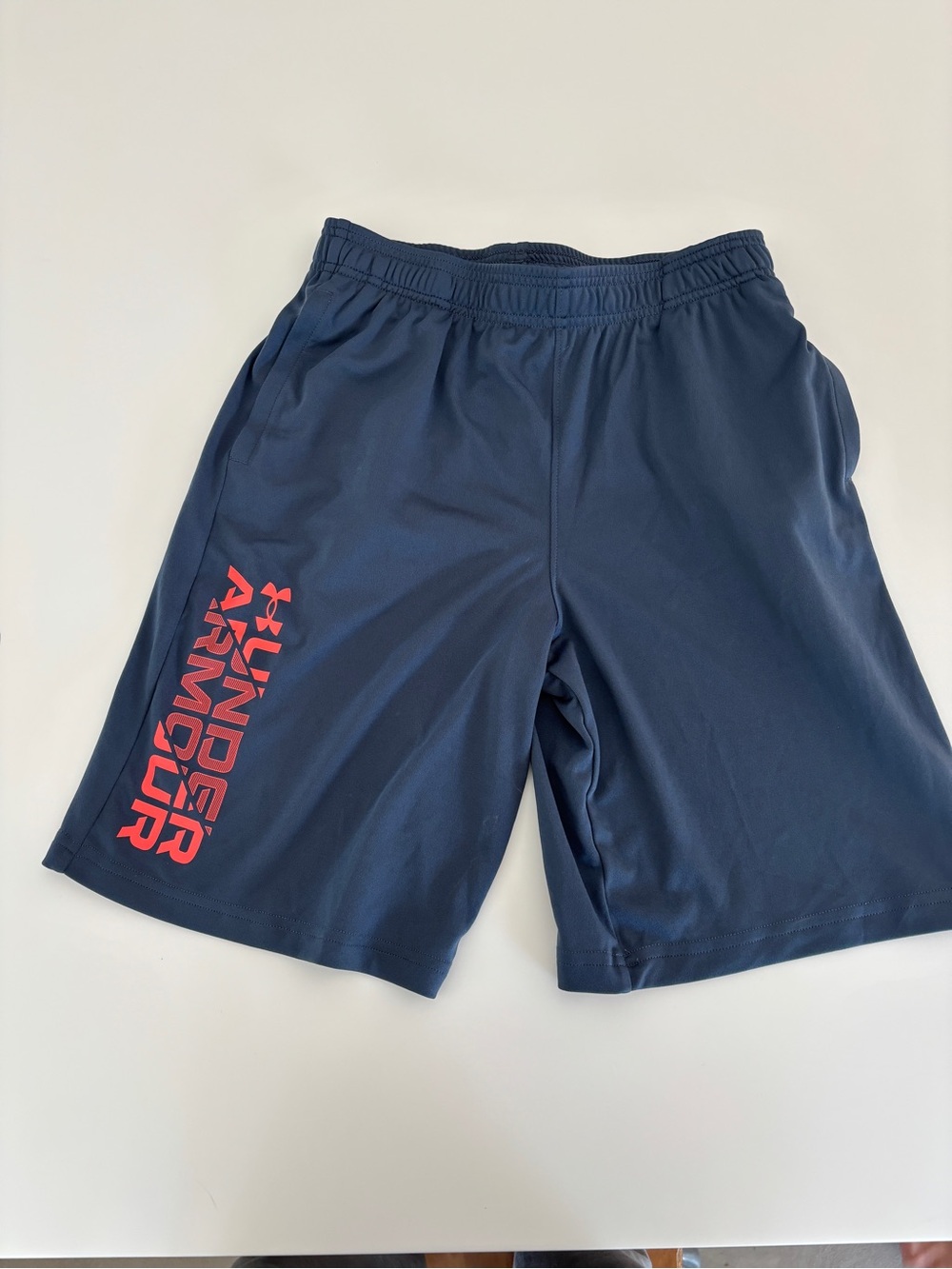 Under Armour Youth Large Navy Athletic Shorts with Red Logo Text